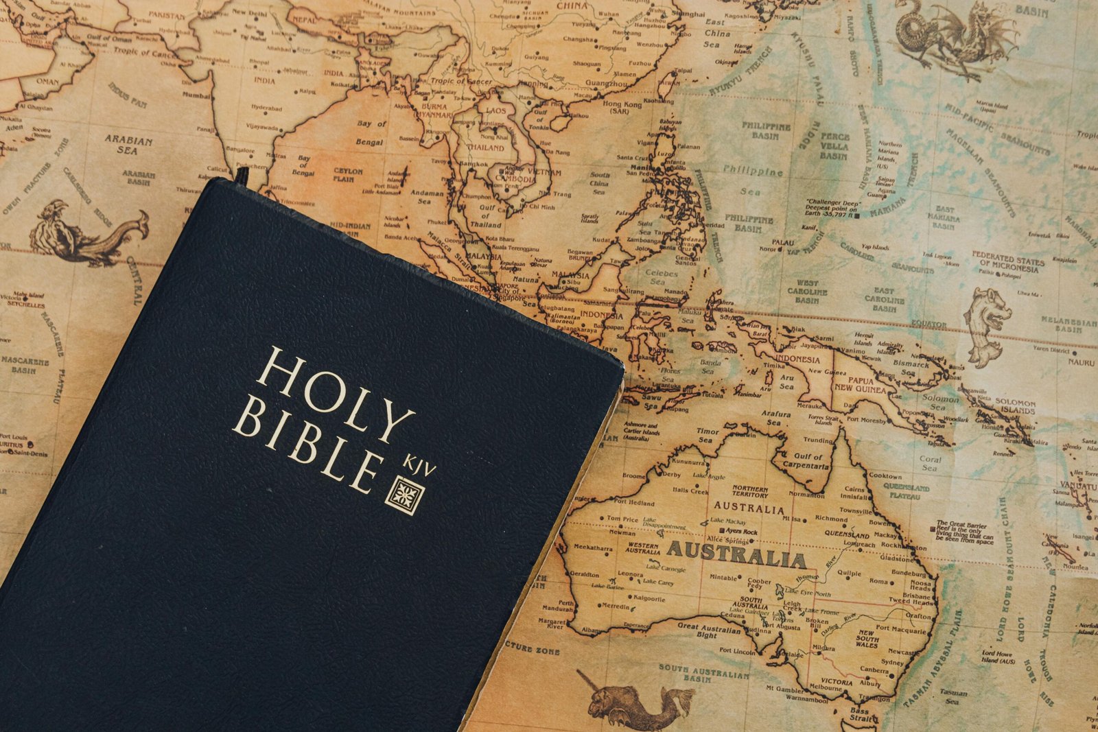 A King James Version Bible placed on a vintage-style world map.